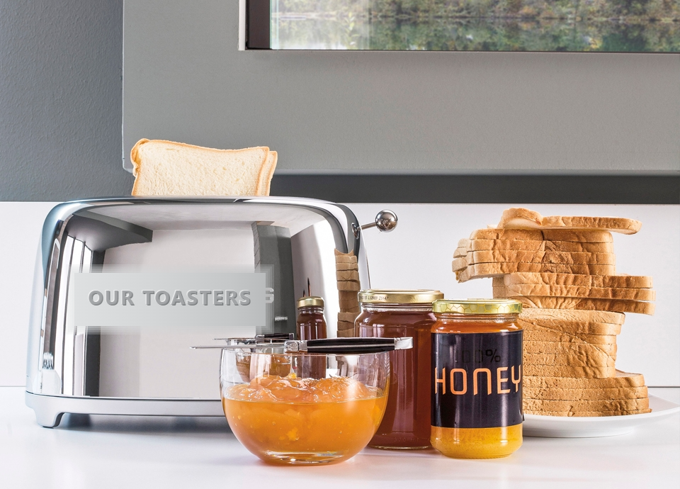 Toast rising beside jars of honey and marmalade