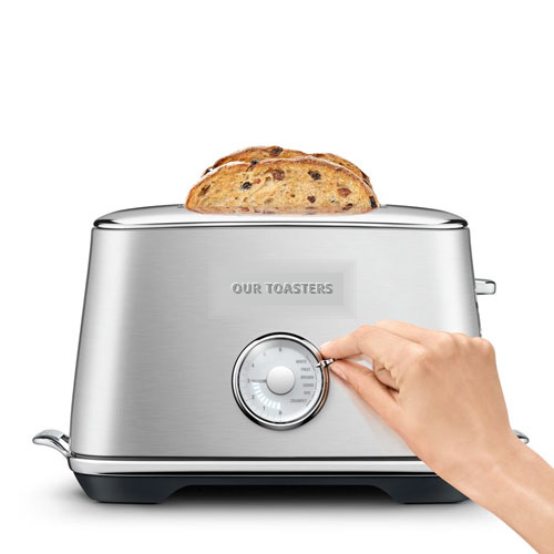 Brushed steel toaster with a slice of raisin bread